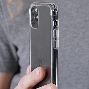 May include: A clear phone case with a black phone inside. The case has a raised lip around the camera lens and buttons.
