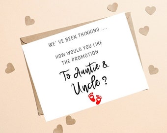 May include: A white card with black text that reads "We've been thinking... How would you like the promotion to Auntie & Uncle?" with two red footprints below the text.