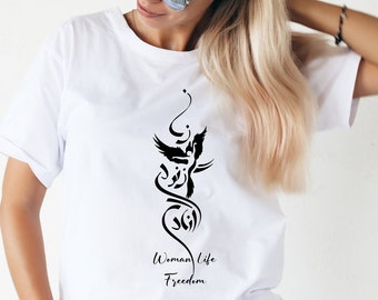 May include: White t-shirt with a black graphic design featuring a stylized bird and the text "Woman Life Freedom".