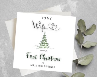 May include: A white card with a Christmas tree illustration and the text "To my Wife" with two hearts, "On our First Christmas as Mr. & Mrs. Feissner".