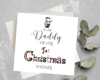 May include: A white card with a black and white panda illustration wearing a Santa hat. The card says "To my Daddy on our 1st Christmas Together".