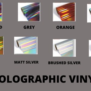 May include: Assortment of holographic vinyl rolls in various colors, including rose gold, grey, orange, mint, gold, matt silver, brushed silver, and silver.  HOLOGRAPHIC VINYL.