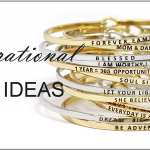 May include: A stack of gold and silver bangle bracelets with inspirational messages engraved on them. The messages include "Forever Family Mom & Daughter", "Blessed I Am Worthy, I Am Loved", "1 Year = 365 Opportunities", "Soul Sisters", "Let Your Light Shine", "She Believed She Could", "Everyday Is A Second Chance", "Dream Big", and "Be Adventurous".