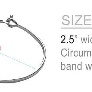 May include: Silver bangle bracelet with the words "Free Spirit" engraved on the front. The bracelet is 2.5 inches wide, 2 inches deep, and has a circumference of 7.5 inches. The band width is 0.25 inches.