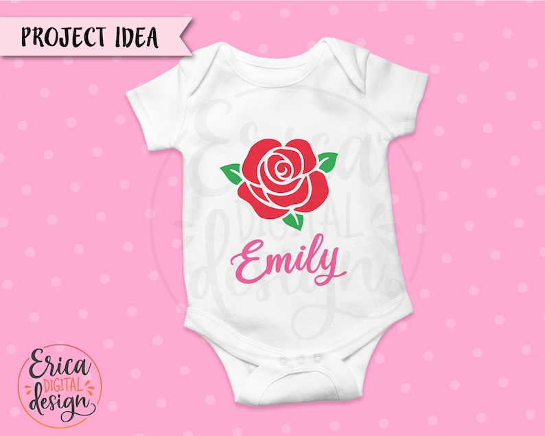 May include: White baby onesie with a red rose and green leaves. The name "Emily" is written in pink below the rose.