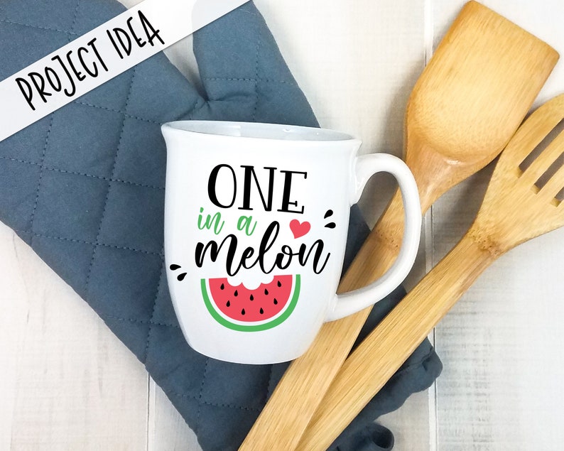 May include: White ceramic mug with a black and white graphic that says "One in a melon" with a red heart and a green watermelon graphic.