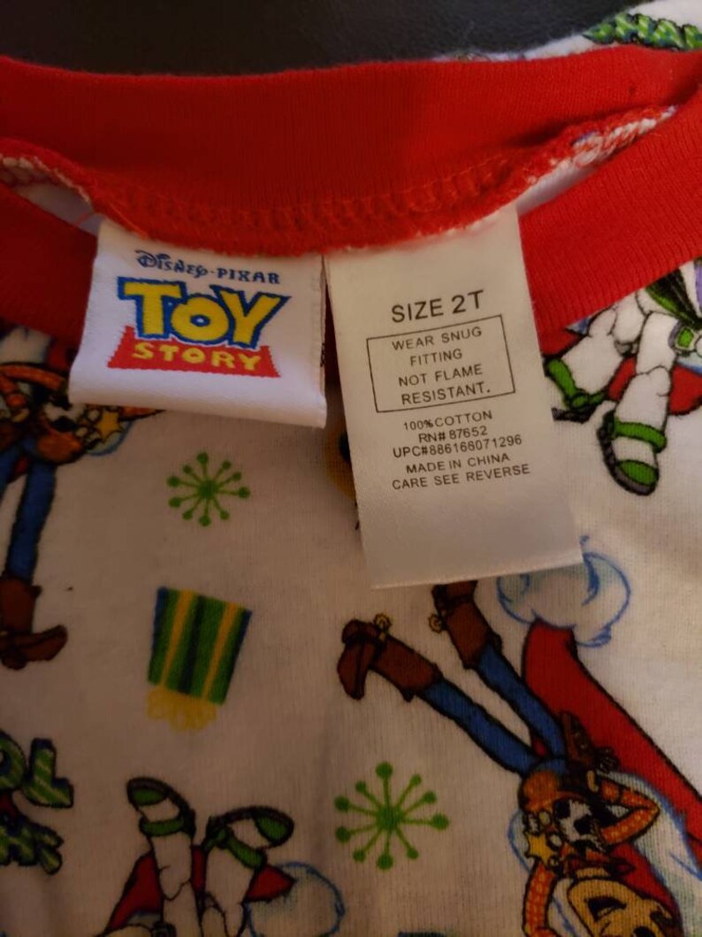 Share your Toys on it. Disney Pixar Toy Story Holiday pajamas Size 2T Long sleeve shirt and pants Woody and Buzz Lightyear have santa hats