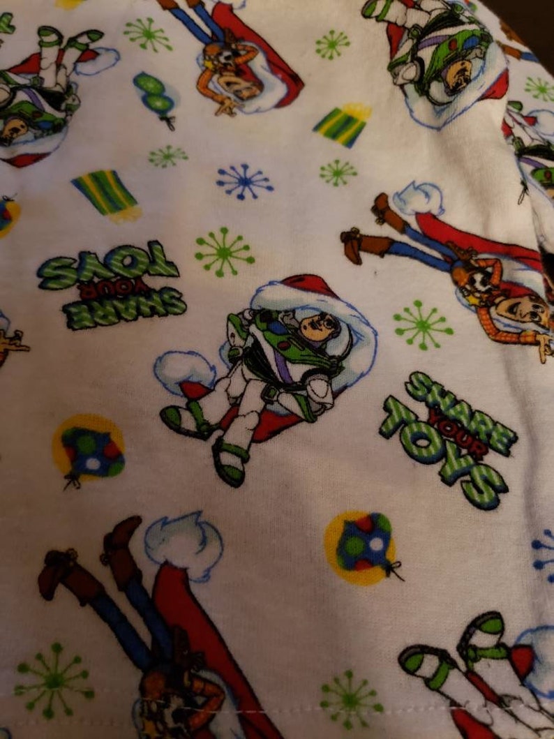 Share your Toys on it. Disney Pixar Toy Story Holiday pajamas Size 2T Long sleeve shirt and pants Woody and Buzz Lightyear have santa hats