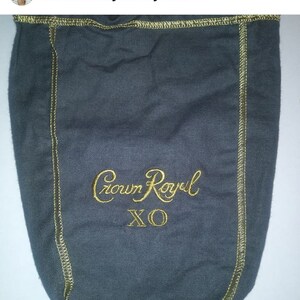 May include: Gray fabric bag with a gold embroidered design that says "Crown Royal XO".