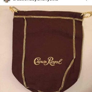May include: A brown drawstring bag with gold stitching and the words "Crown Royal" embroidered in gold.