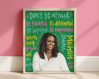 May include: A framed wall art print featuring a portrait of Michelle Obama in a white shirt against a green background. The text reads: Don't be afraid. Be focused. Be determined. Be hopeful. Be empowered. When they go low, we go high. Michelle Obama first lady.