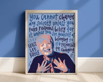 May include: A framed art print featuring a stylized portrait of Grace Lee Boggs in shades of dark blue, light blue, and peach. The text reads: You cannot change any society unless you take responsibility for it, unless you see yourself as belonging to it and responsible for changing it.