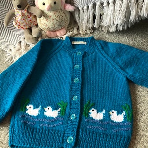 Girls or baby Cardigan with swimming ducks front and back. 2-3 years  ready now