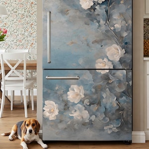 May include: A refrigerator door with a blue and white floral design. The design features white flowers with blue leaves and stems. The background is a light blue watercolor wash. The refrigerator is a stainless steel finish.
