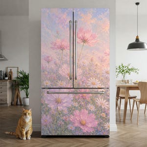 May include: A French door refrigerator featuring a full-coverage wrap with an impressionistic floral design. The artwork displays soft pink and lavender cosmos flowers against a pastel sky background, complemented by vertical silver metal handles.