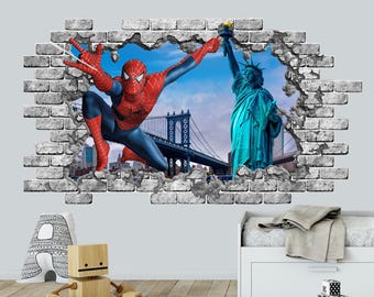 May include: A wall decal featuring a 3D-style hole in a brick wall revealing a scene of Spider-Man in a red and blue suit, the Statue of Liberty, and the Manhattan Bridge against a blue sky. The design creates an illusion of a broken wall.