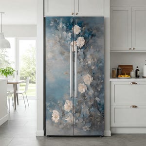 May include: Refrigerator with a floral design. The design features white flowers and green leaves against a blue and gray background. The refrigerator has two silver handles and is in a kitchen setting.