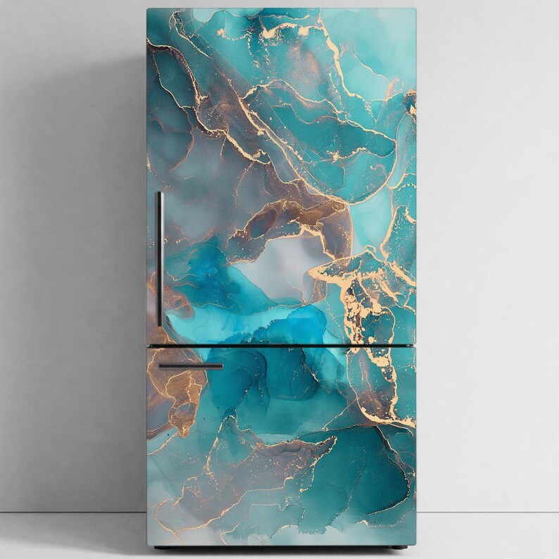 a refrigerator with a striking marble-like design in shades of blue, gold, and white. The design appears to be a liquid-style pattern, with swirling and intermingled colors that create a sense of depth and movement. The refrigerator is standing against a plain white wall, which highlights the vibrant colors and intricate design of the appliance.