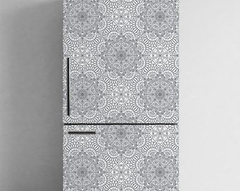 May include: A refrigerator with a white and gray mandala pattern. The design covers the entire front of the appliance, including the doors and handles. The pattern is symmetrical and detailed, creating a decorative and artistic look.