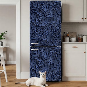 May include: A navy blue refrigerator with a decorative floral pattern. The design features swirling leaves and vines in varying shades of blue. The refrigerator has silver handles and is in a kitchen setting.
