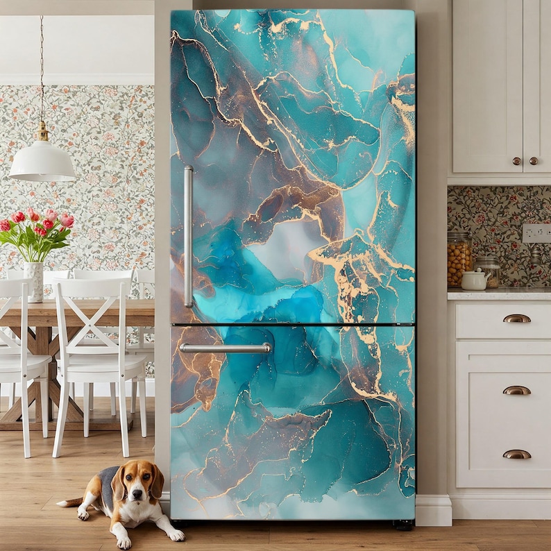 a refrigerator with a vibrant turquoise and gold marble-like design, creating a striking and modern aesthetic. A dog is sitting on the floor in front of the refrigerator, adding a cozy and homely touch to the scene.