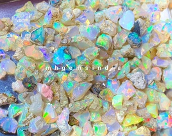 May include: A collection of rough opal gemstones in various shades of white, blue, green, and pink. The opals are iridescent and have a natural, raw appearance.