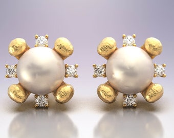 May include: A pair of gold earrings with a pearl and diamond accents. Each earring features a round pearl surrounded by small diamonds set in gold.