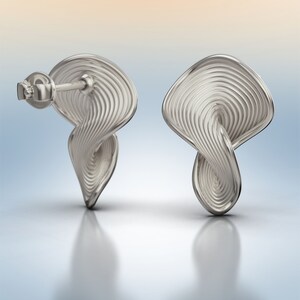 May include: A pair of silver earrings with a unique, twisted, and textured design. The earrings have a post back closure.