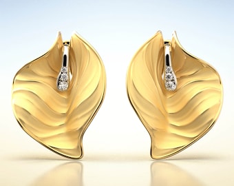 May include: A pair of gold leaf-shaped earrings with a small diamond accent on each earring.