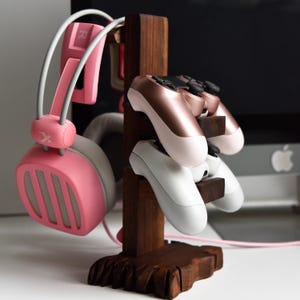 May include: A white ceramic mug with a black handle and the text "But First, Coffee" in a handwritten style. The mug is on a white surface. The mug is approximately 4 inches tall.