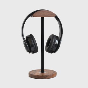 May include: A black headphone stand with a wooden base and a wooden top piece. The headphones are black with a black headband.