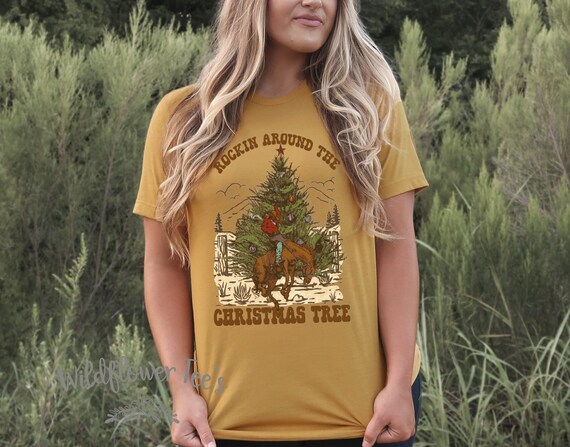 Women's ROCKIN AROUND The Christmas Tree Buckin Bronco Cowboy Ranch Farm Country Barn Graphic Tee T-Shirt Plus Sizes Avail up to 4XL