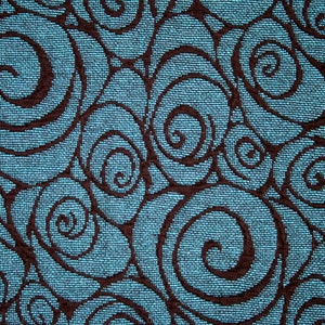 May include: A blue fabric with a repeating pattern of brown swirls. The swirls are stylized to look like roses.