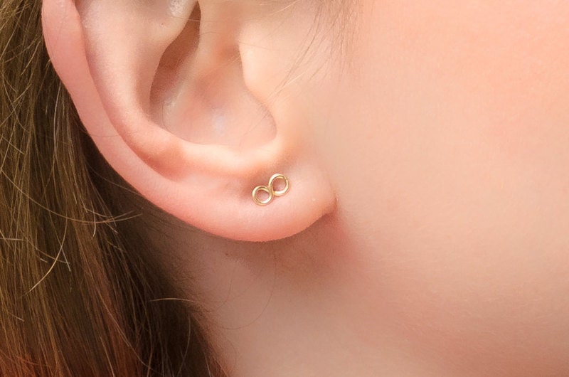 Gold infinity earrings on sale studs