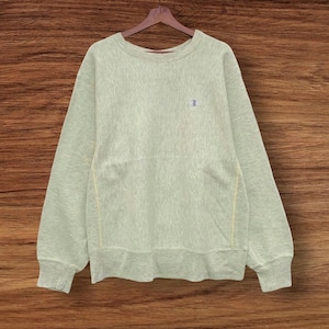 May include: A light green Champion sweatshirt with a small white logo on the left chest.