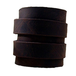 May include: A stack of four brown leather straps, each with a distressed finish.