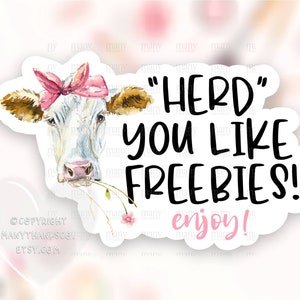 May include: A white cow with brown spots and a pink bow is drawn in a watercolor style. The cow is eating a green blade of grass. The text "HERD YOU LIKE FREEBIES! enjoy!" is written in black on a white background.