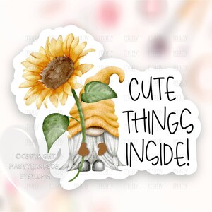 May include: A sticker featuring a cute gnome holding a sunflower with the text "Cute Things Inside!"