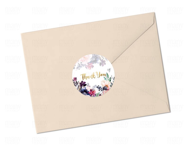 May include: A round, white sticker with a floral design in shades of purple, pink, and blue. The sticker has the words "Thank You" written in gold lettering.