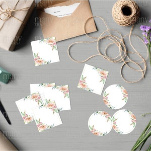 May include: A set of blank gift tags and labels with a floral design. The tags are white with a pink and green floral border. There are three round labels and four square labels.