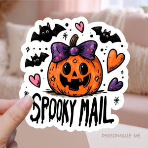 May include: A Halloween sticker with an orange pumpkin, purple bow, bats, and hearts. The sticker reads "SPOOKY MAIL" in a dripping font. The design is whimsical and colourful, ideal for seasonal decorations and adding a touch of spooky fun.