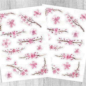 May include: A sheet of pink and white watercolor stickers featuring cherry blossoms. The stickers are arranged in a grid pattern on a white background.