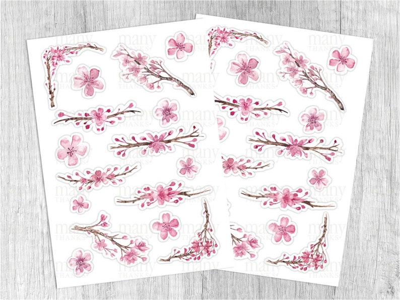 May include: A sheet of pink and white watercolor stickers featuring cherry blossoms. The stickers are arranged in a grid pattern on a white background.