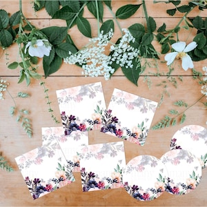 May include: Set of seven floral-themed gift tags and labels. The tags are square and the labels are round. The floral design features pink, purple, and green watercolor flowers on a white background.