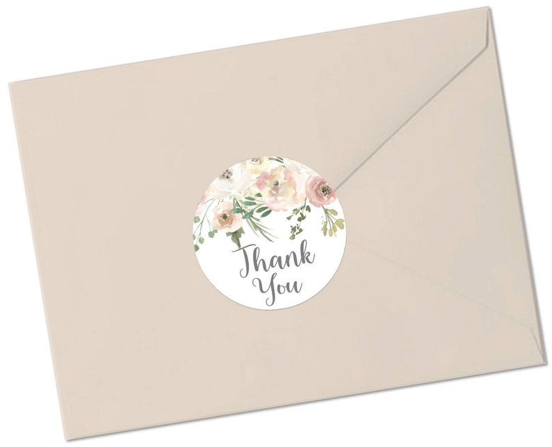 May include: A round thank you sticker featuring a watercolour floral design in shades of pink and white. The sticker has the text "Thank You" in grey lettering.
