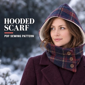 May include: A hooded scarf with a dark blue and red plaid pattern, featuring a cream-colored lining and three brown buttons on the side. The text HOODED SCARF PDF SEWING PATTERN is visible on the left side of the image against a blurred snowy background.