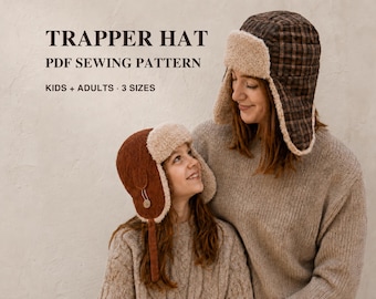 May include: A PDF sewing pattern for a trapper hat in kids and adult sizes. The text reads TRAPPER HAT PDF SEWING PATTERN KIDS + ADULTS 3 SIZES. The image shows two trapper hats with ear flaps, one in brown plaid and one in solid brown corduroy.