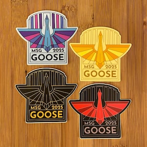 May include: Four stickers with a stylized bird design. Each sticker features a bird with outstretched wings, the text "MSG 2025 GOOSE", and a unique color scheme: purple and blue, yellow and orange, black and gold, and red and black.