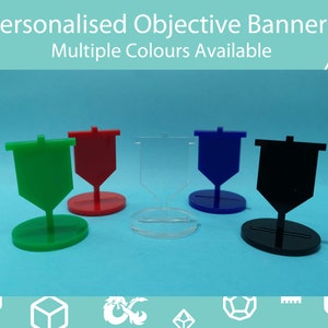 May include: Five objective banners in green, red, clear, blue, and black. Each banner has a flag shape and sits on an oval base. Text at the top says "Personalised Objective Banners Multiple Colours Available".