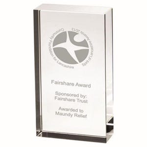 May include: A clear, rectangular Fairshare Award trophy. The trophy has a gray logo and text that reads "Community Foundation for Lancashire" and "Fairshare Award". The award is sponsored by Fairshare Trust and awarded to Maundy Relief.